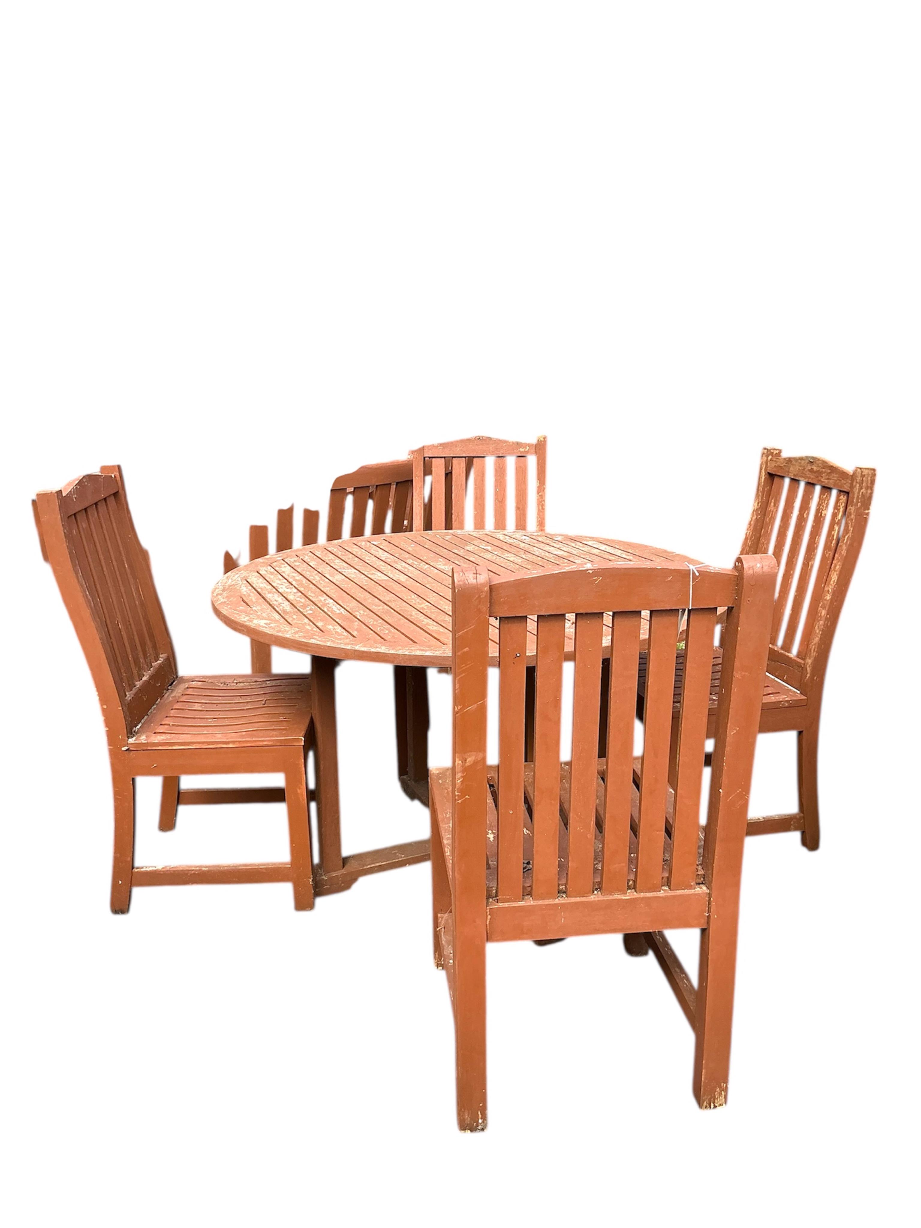 A circular stained teak garden table, diameter 120cm, height 72cm and four chairs
